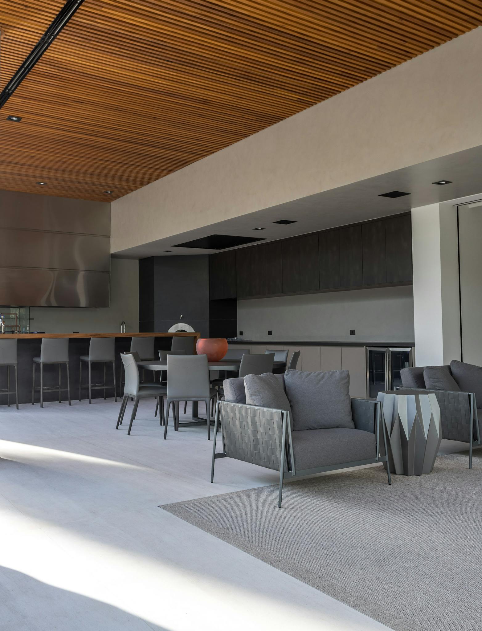 Spacious modern living room with sleek furnishings and open kitchen design.